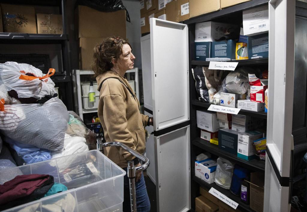 Jasmine Donahue shows her medicine cabinet where people are able to safely store and have access to their medications on Thursday, Jan. 9, 2025, in Everett, Washington. (Olivia Vanni / The Herald)