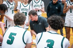 Jackson head coach Steve Johnson runs through a play with his team during a timeout on Friday, Dec. 27, 2024 in Mountlake Terrace, Washington. (Olivia Vanni / The Herald)