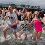 Children emerge from the Polar Bear Plunge on Wednesday, Jan. 1, in Edmonds, Washington. (Will Geschke / The Herald)