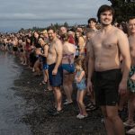 Hundreds lined up along Brackett's Landing to take part in the traditional plunge on Wednesday, Jan. 1 in Edmonds, Washington. (Will Geschke / The Herald)
