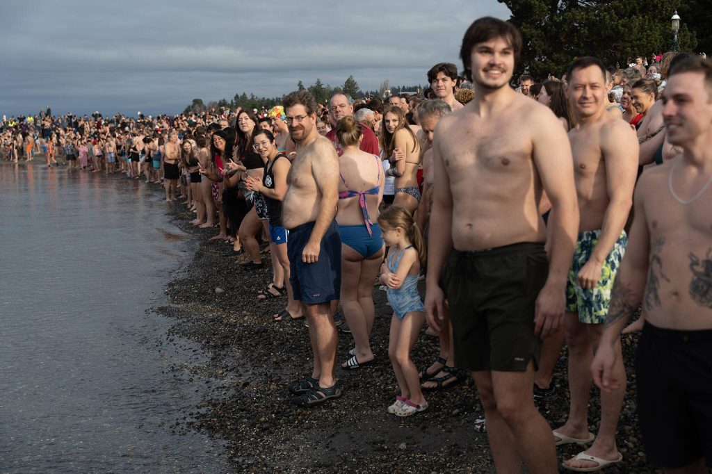 Hundreds lined up along Brackett's Landing to take part in the traditional plunge on Wednesday, Jan. 1 in Edmonds, Washington. (Will Geschke / The Herald)