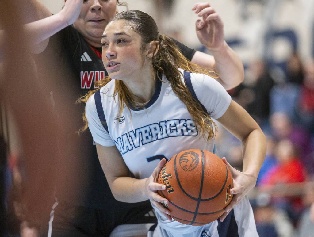 Meadowdales Kaiya Dotter tries to maneuver around Archbishop Murphy players to get a clear shot during the game on Friday, Jan. 3, 2025 in Lynnwood, Washington. (Olivia Vanni / The Herald)