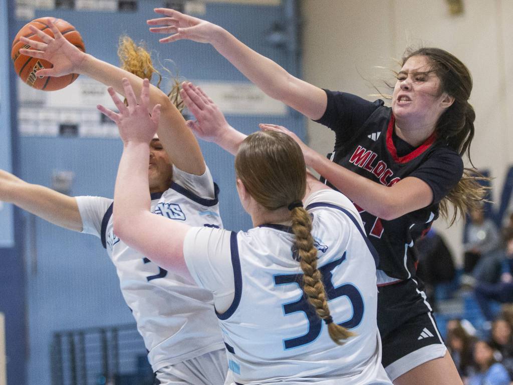 Archbishop Murphys Ava Marr leaps in the air for a rebound during the game against Meadowdale on Friday, Jan. 3, 2025 in Lynnwood, Washington. (Olivia Vanni / The Herald)