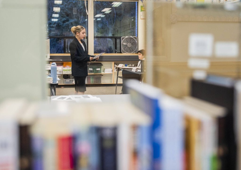 Gracie Watson interviews a witness during a mock trial at 10th Street Middle School on Friday, Jan. 10, 2025, in Marysville, Washington. (Olivia Vanni / The Herald)