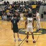 Edmonds-Woodway boys basketball (green) and Shorecrest (white) prepare for tipoff ahead of a league matchup at Shorecrest High School on Jan. 8, 2025. (Qasim Ali / The Herald)