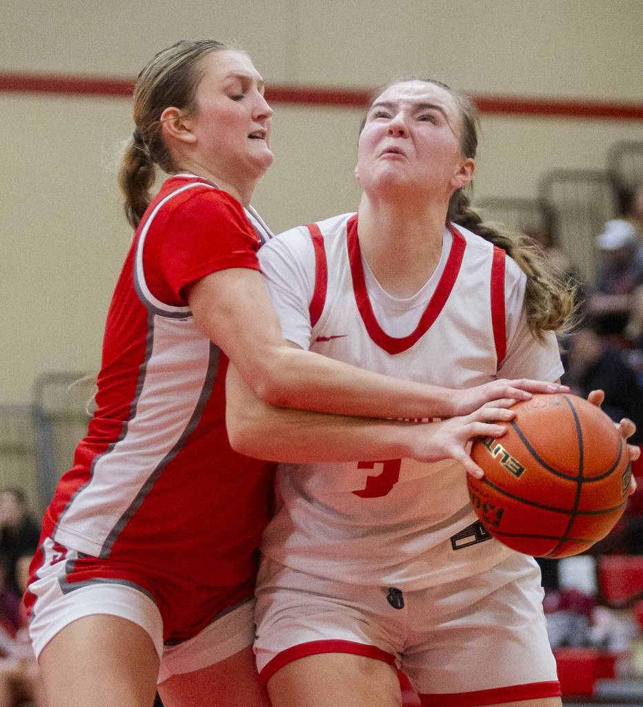 Stanwoods Ava DePew fouls Snohomishs Kendall Hammer as she tries to take a shot during the game on Thursday, Jan. 9, 2025 in Snohomish, Washington. (Olivia Vanni / The Herald)