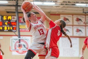 Snohomish’s Sienna Capelli is fouled by Stanwood's Georgia Lenz while trying to take a shot during the game on Thursday, Jan. 9, 2025 in Snohomish, Washington. (Olivia Vanni / The Herald)