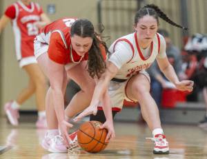 Stanwood's Jazmyn Legg and Snohomish’s Sienna Capelli scramble for a loose ball during the game on Thursday, Jan. 9, 2025 in Snohomish, Washington. (Olivia Vanni / The Herald)