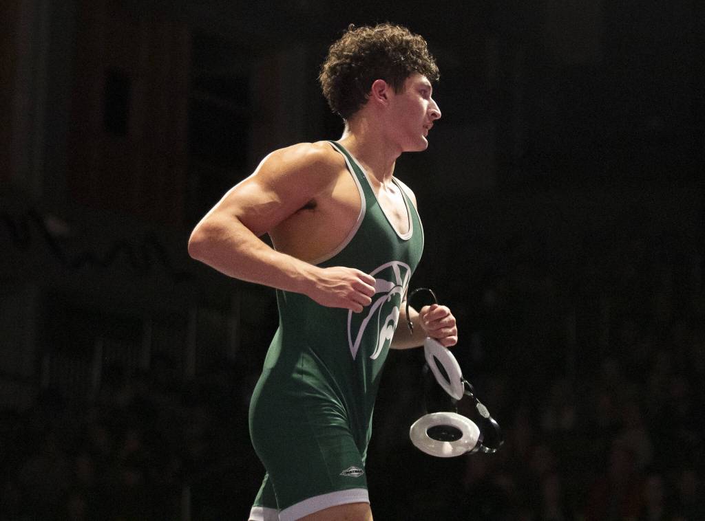Edmonds-Woodways Ever Yamada runs off the mat after winning the 175-pound match on Thursday, Jan. 16, 2025 in Edmonds, Washington. (Olivia Vanni / The Herald)