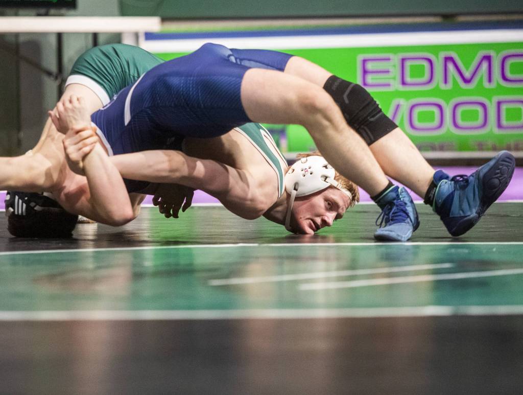 Edmonds-Woodways Dylan Rice tries to push Meadowdales Logan Palmer toward the mat during the 144-pound match on Thursday, Jan. 16, 2025 in Edmonds, Washington. (Olivia Vanni / The Herald)
