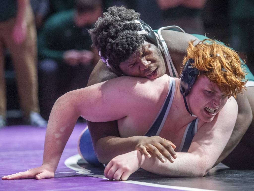 Meadowdales Jaxson Hulbert grimaces as Edmonds-Woodways Edson Belizaire gains control of his back during the 285-pound match on Thursday, Jan. 16, 2025 in Edmonds, Washington. (Olivia Vanni / The Herald)