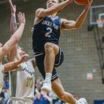 Glacier Peaks Jo Lee leaps in the air past multiple Arlington players to make a layup during the game on Friday, Jan. 17, 2025 in Arlington, Washington. (Olivia Vanni / The Herald)