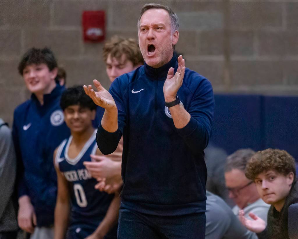 Glacier Peak head coach Brian Hunter yells in celebration after a three point shot during the game against Arlington on Friday, Jan. 17, 2025 in Arlington, Washington. (Olivia Vanni / The Herald)