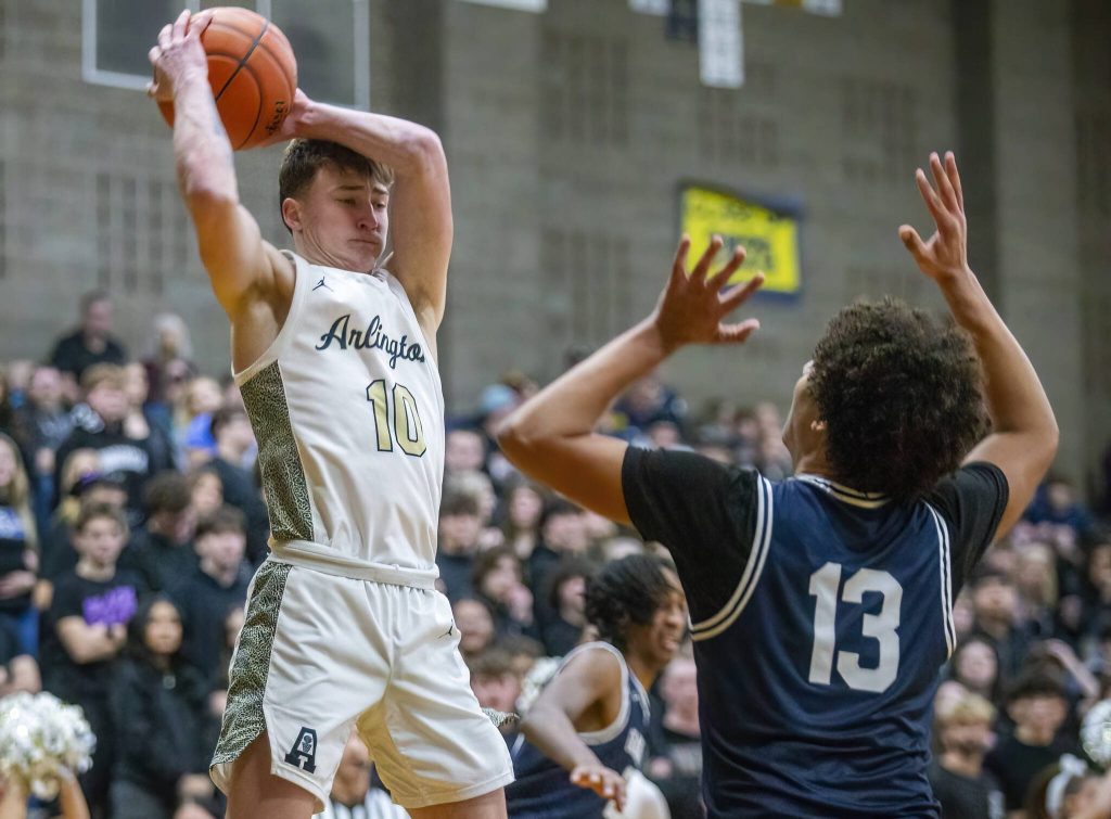 Arlingtons Kaid Hunter leaps in the air for a rebound during the game against Glacier Peak on Friday, Jan. 17, 2025 in Arlington, Washington. (Olivia Vanni / The Herald)