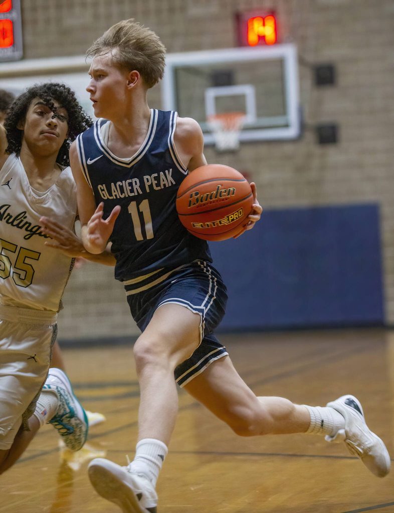 Glacier Peaks Reed Nagel drives to the hoop during the game against Arlington on Friday, Jan. 17, 2025 in Arlington, Washington. (Olivia Vanni / The Herald)