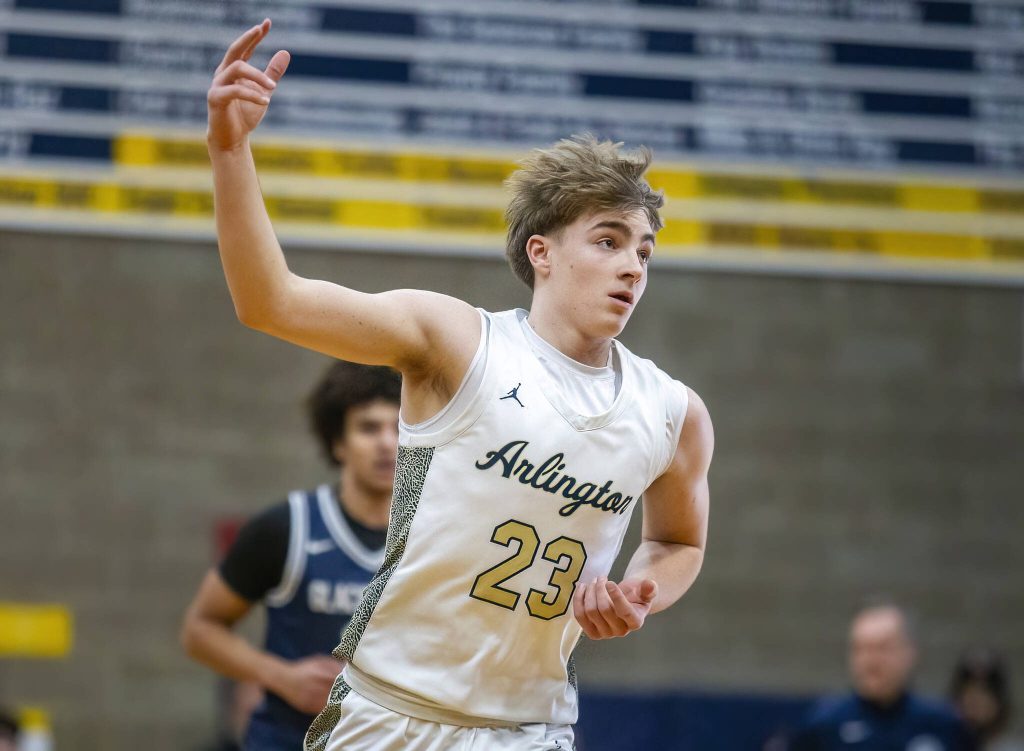 Arlingtons Leyton Martin puts three fingers in the air after making a three point shot during the game against Glacier Peak on Friday, Jan. 17, 2025 in Arlington, Washington. (Olivia Vanni / The Herald)