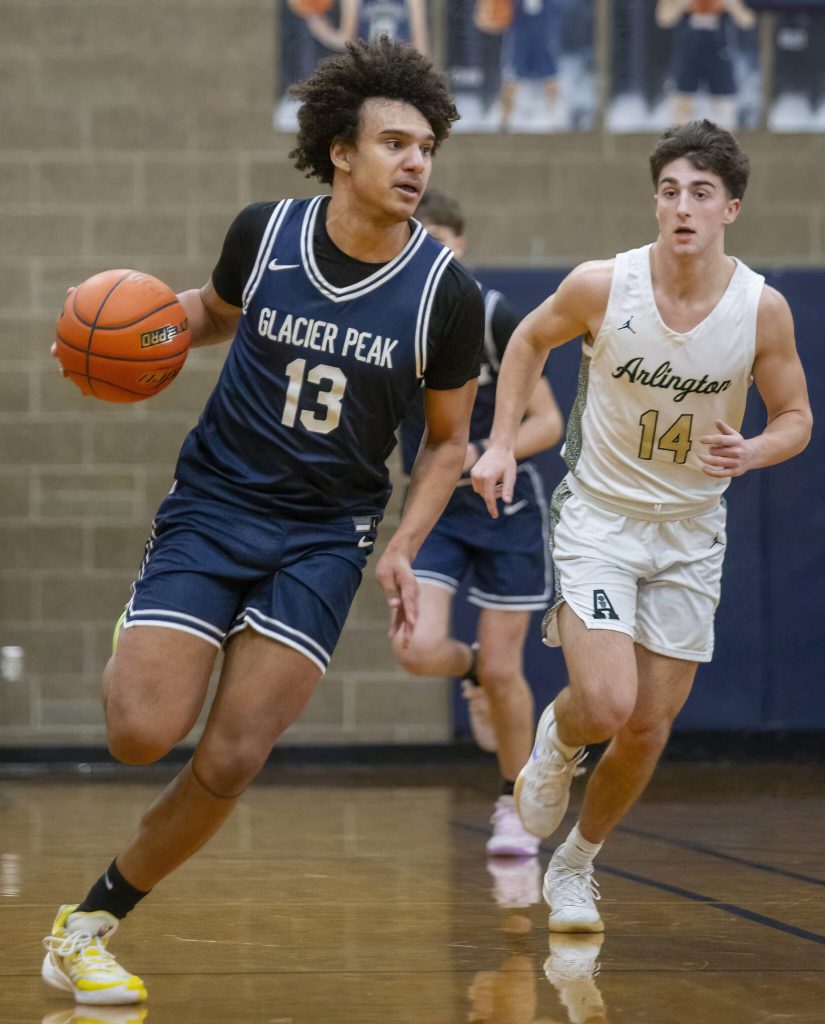 Glacier Peaks Jayce Nelson takes the ball down the court during the game against Arlington on Friday, Jan. 17, 2025 in Arlington, Washington. (Olivia Vanni / The Herald)