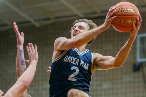 Glacier Peak’s Jo Lee leaps in the air past multiple Arlington players to make a layup during the game on Friday, Jan. 17, 2025 in Arlington, Washington. (Olivia Vanni / The Herald)