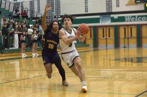 Jacksons Mason Engen (3) tries to drive past Mariners Tobias Alexander (10) in a Wesco 4A game on Friday, Jan. 17 at Jackson High School. (Aaron Coe / The Herald)