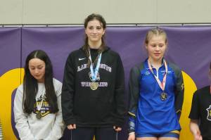Kamiak wrestler Eden Cole rests atop the awards stand after winning the 135 class at the Justice for All tournament at Issaquah High School on Saturday, Jan. 18, 2025. (Photo courtesy of Kamiak High School wrestling)