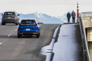 Two pedestrians navigate their way down a frosted over sidewalk along Pacific Avenue on Monday, Jan. 20, 2025 in Everett, Washington. (Olivia Vanni / The Herald)