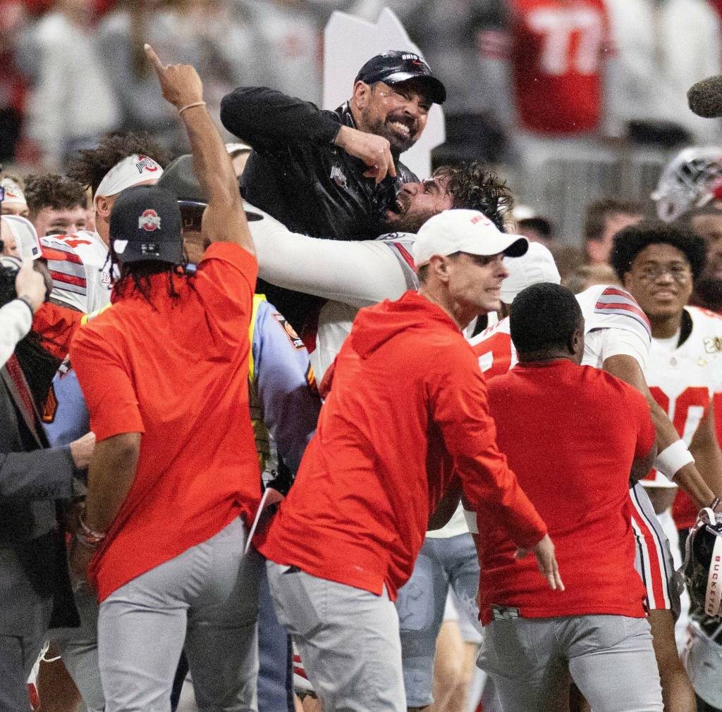 OSU head coach Ryan Day is hoisted into the air at the end of the 2025 CFP National Championship game between the Ohio State Buckeyes and Notre Dame Fighting Irish at Mercedes-Benz Stadium in Atlanta on Monday, January 20, 2025. OSU won 34-23. (David Petkiewicz, Tribune News Services)