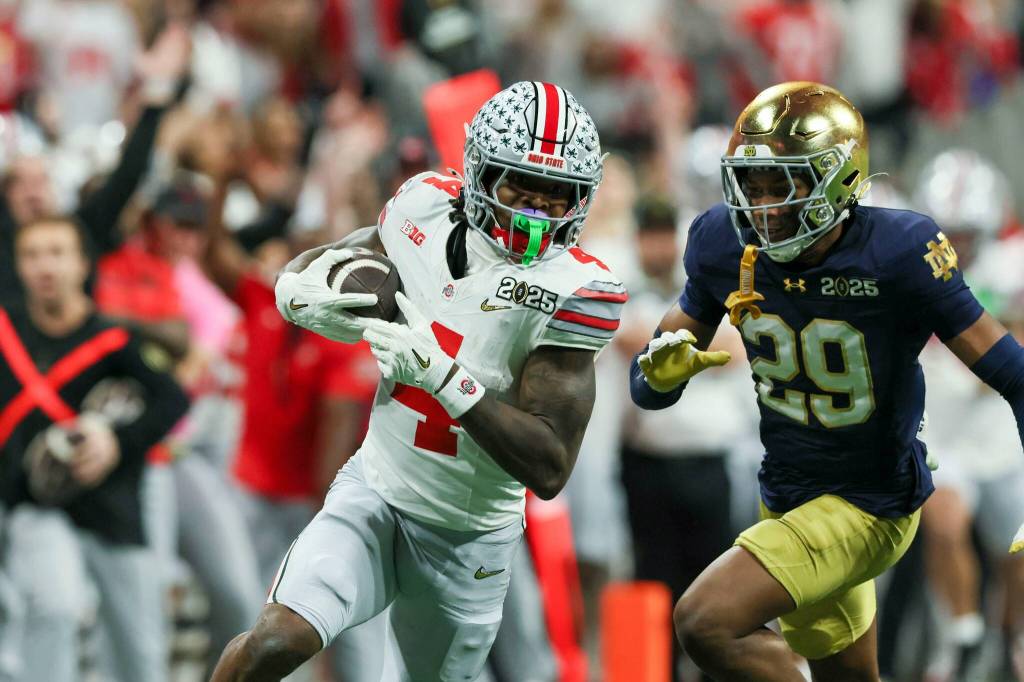 Ohio State wide receiver Jeremiah Smith (4) makes a 56-yard reception against Notre Dame cornerback Christian Gray (29) during the fourth quarter in the 2025 National Championship at Mercedes-Benz Stadium, Monday, Jan. 20, 2025, in Atlanta. Ohio State won 34-23. (Jason Getz / AJC / Tribune News Services)