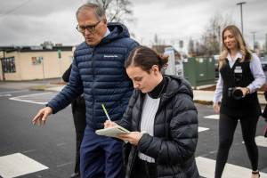 Olivia Vanni / The Herald
Former Everett Herald reporter TaLeah Van Sistine walks with former Gov. Jay Inslee while taking notes on Feb. 6, 2024, in Marysville.