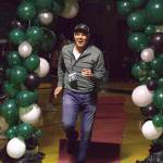 Alan Briggs, coach of the 2006 state-champion baseball team, jogs through the balloon arch at an Athletic Hall of Fame ceremony at Jackson High School in Mill Creek on Jan. 17. (Aaron Coe / The Herald)