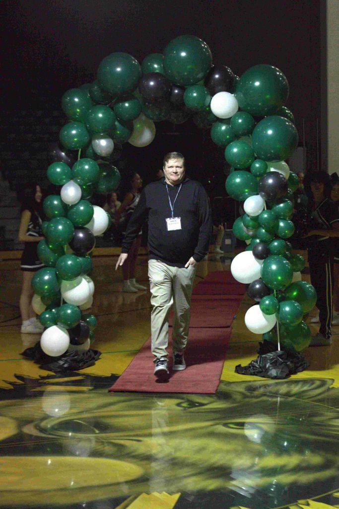 Dustin Duke, Jacksons first-ever state champion, walks through the balloon arch at an Athletic Hall of Fame ceremony at Jackson High School in Mill Creek on Jan. 17. (Aaron Coe / The Herald)