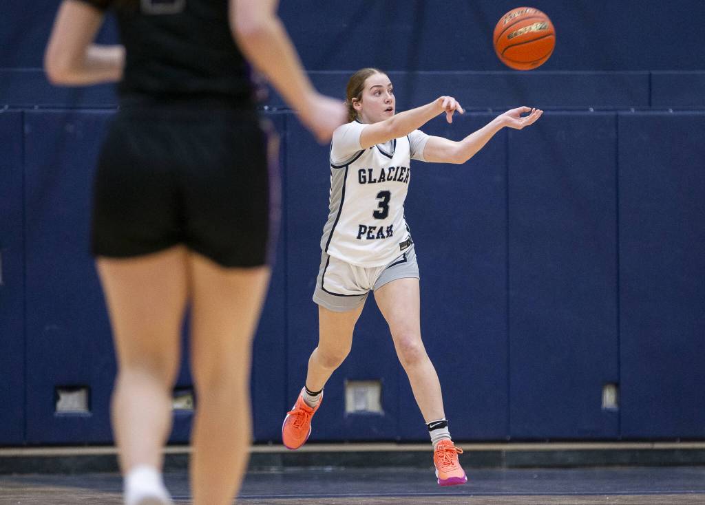 Glacier Peaks Brynna Pukis leaps in the air to pass the ball during the game on Friday, Jan. 24, 2025 in Snohomish, Washington. (Olivia Vanni / The Herald)