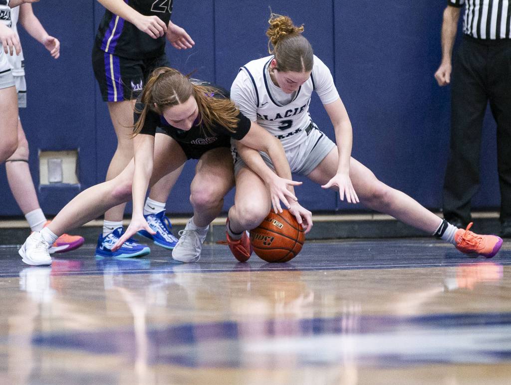 Glacier Peaks Brynna Pukis and Lake Stevens Griffyn Eyman scramble for the ball during the game on Friday, Jan. 24, 2025 in Snohomish, Washington. (Olivia Vanni / The Herald)