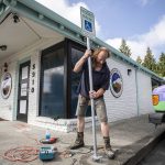 Housing Hope maintenance Dennis Willard installs a handicap sign outside of Tomorrows Hope on Friday, Sept. 1, 2023, in Everett, Washington. (Olivia Vanni / The Herald)