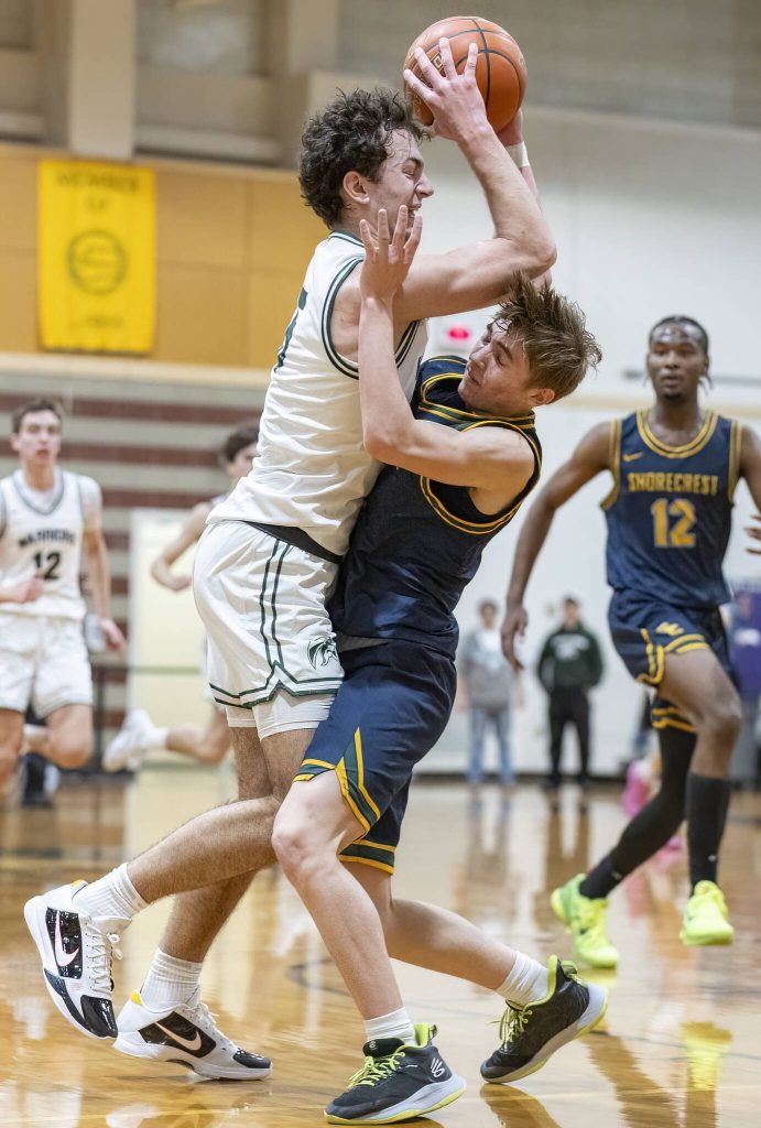 Edmonds-Woodways Cam Hiatt runs through Shorecrests Brayden Fischer during the game on Tuesday, Jan. 28, 2025 in Edmonds, Washington. (Olivia Vanni / The Herald)
