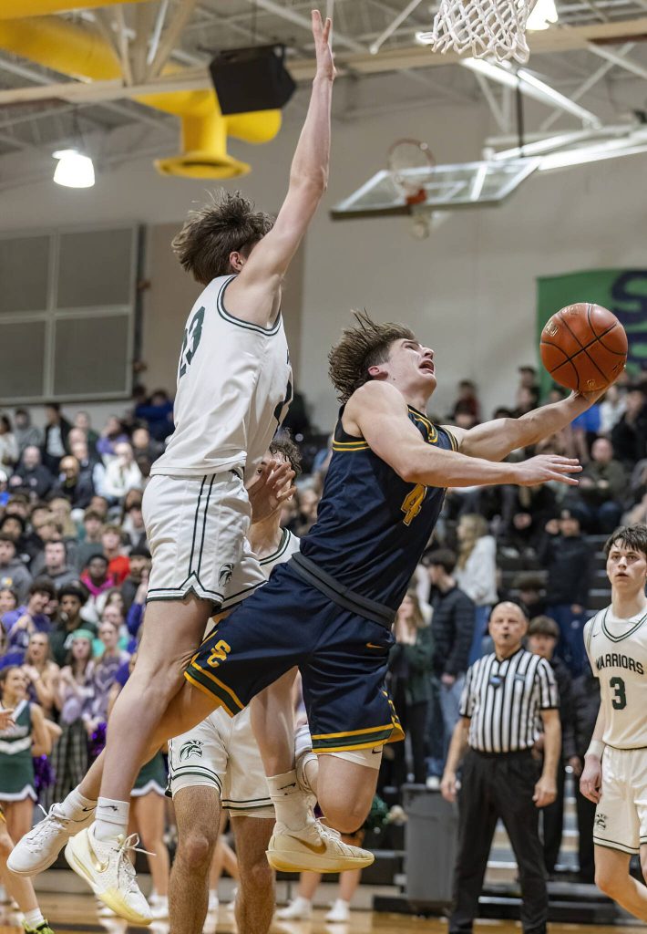 Shorecrests Porter Swanson leaps to try and make a layup during the game against Edmonds-Woodway on Tuesday, Jan. 28, 2025 in Edmonds, Washington. (Olivia Vanni / The Herald)