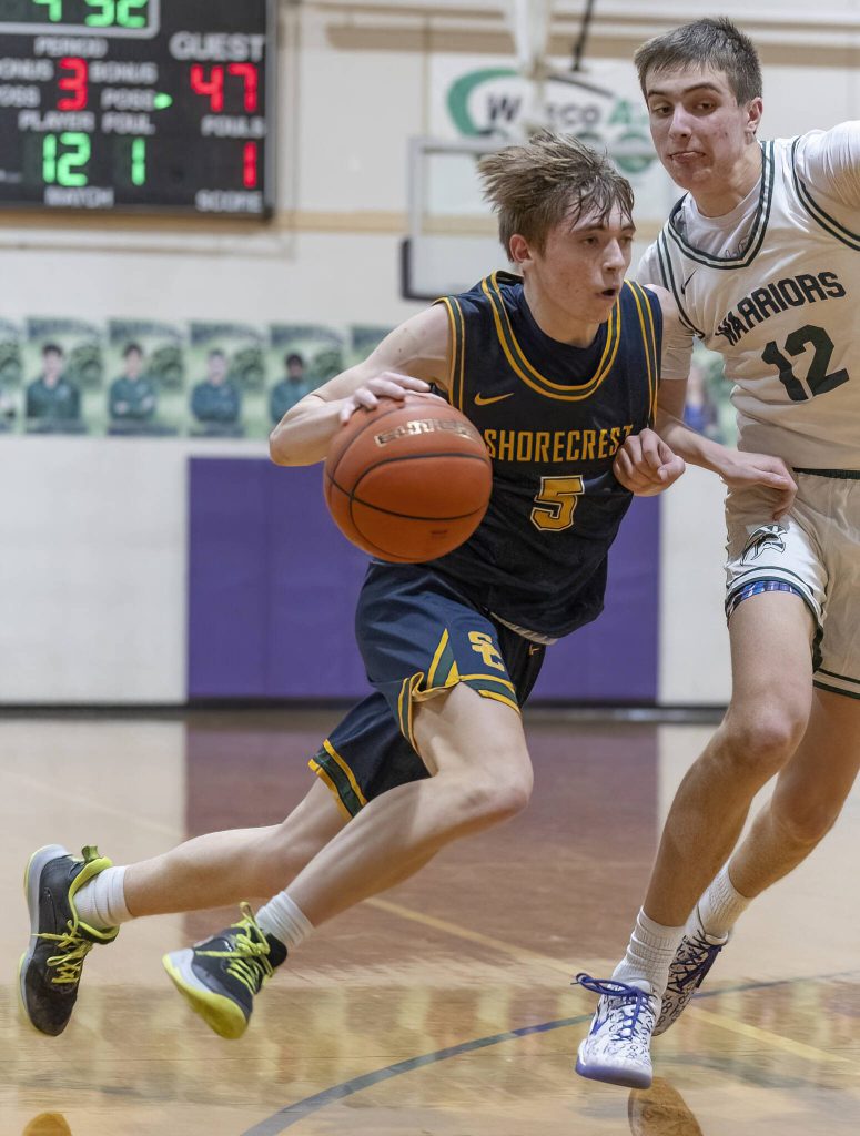 Shorecrests Brayden Fischer tries to maneuver around Edmonds-Woodways William Alseth during the game on Tuesday, Jan. 28, 2025 in Edmonds, Washington. (Olivia Vanni / The Herald)