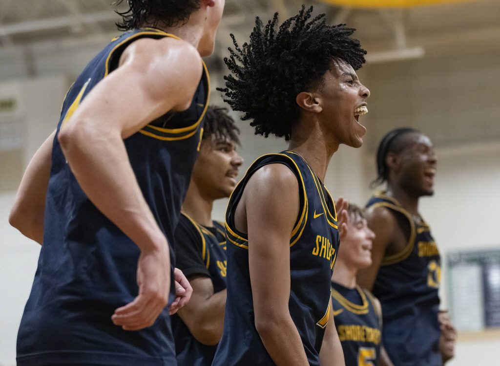 Shorecrests Robel Biniam along with other players on the bench react to a score during the game against Edmonds-Woodway on Tuesday, Jan. 28, 2025 in Edmonds, Washington. (Olivia Vanni / The Herald)