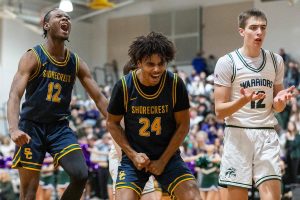 Shorecrest’s Junior Kagarabi and Devan Jones celebrate a foul called on Edmonds-Woodway’s William Alseth who raises his hands in confusion during the game on Tuesday, Jan. 28, 2025 in Edmonds, Washington. (Olivia Vanni / The Herald)