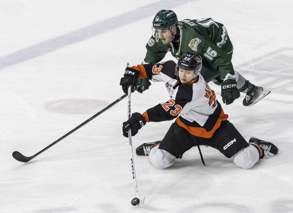 Slivertips Dominik Rymon has the puck taken by Medicine Hats Veeti Väisänen during the game on Wednesday, Jan. 29, 2025 in Everett, Washington. (Olivia Vanni / The Herald)