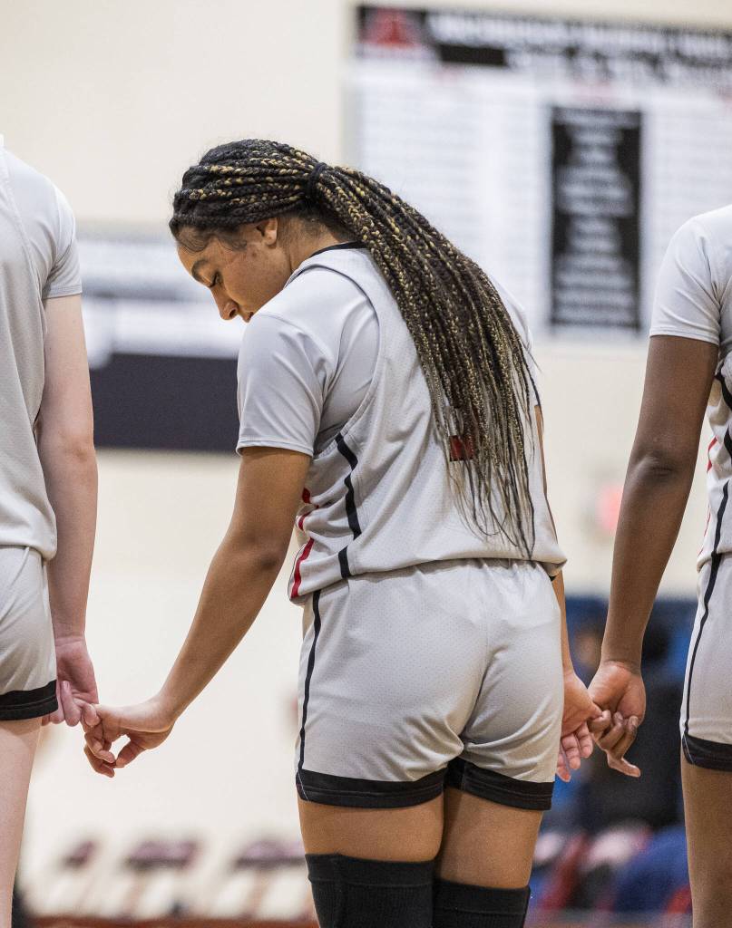 Archbishop Murphys Kayla Hookfin locks pinky fingers with her teammates before the game against Meadowdale on Thursday, Jan. 30, 2025 in Everett, Washington. (Olivia Vanni / The Herald)