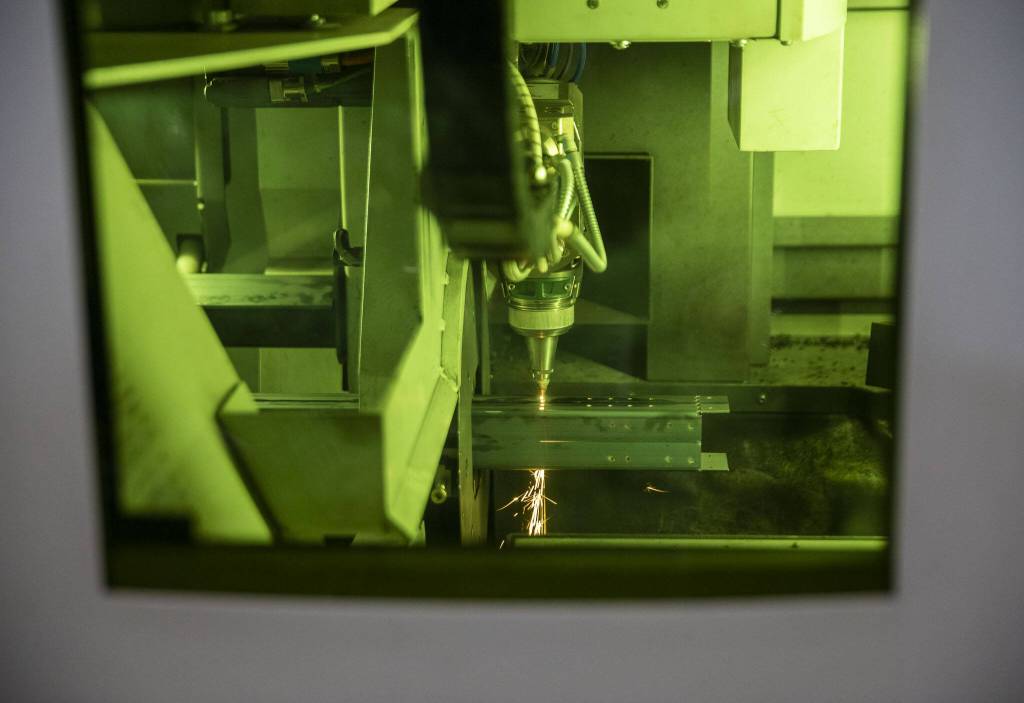 A laser cuts holes on a fireplace part on Thursday, Oct. 3, 2024 in Mukilteo, Washington. (Olivia Vanni / The Herald)