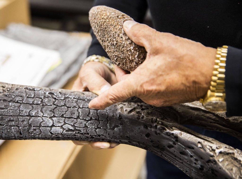 Kurt Rumens talks about the details in the works and rocks placed in gas fireplaces on Thursday, Oct. 3, 2024 in Mukilteo, Washington. (Olivia Vanni / The Herald)