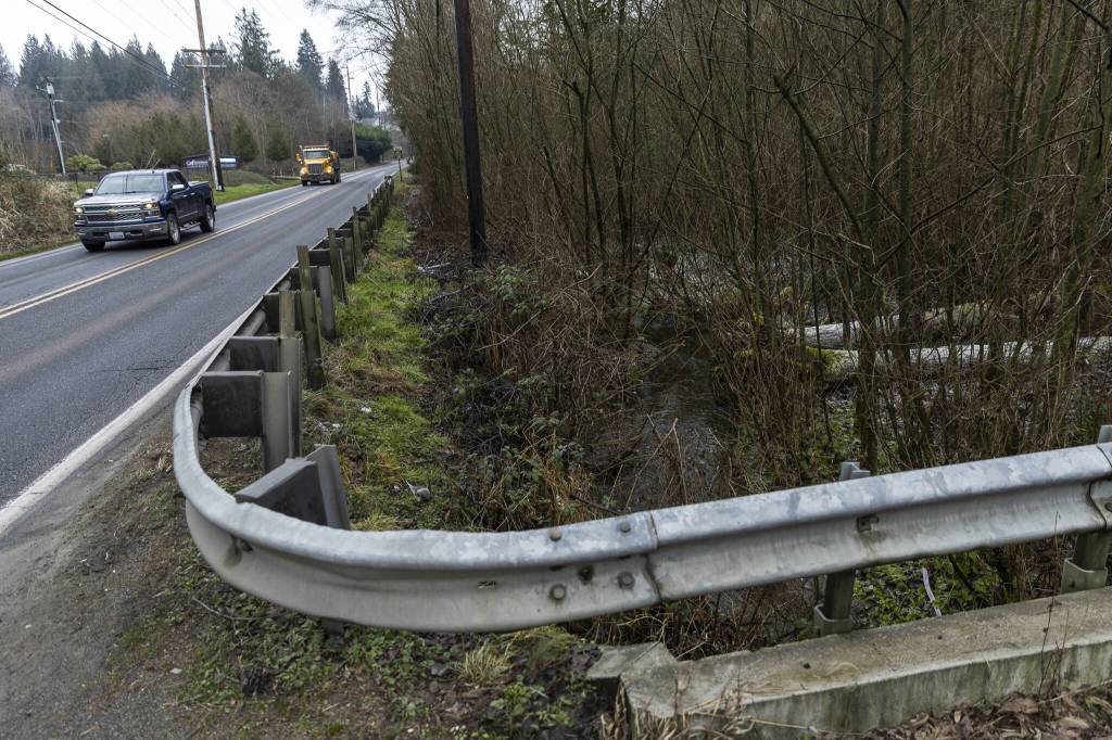 Cars drive along 172nd Street Northeast that runs parallel to Edgecomb Creek on Thursday, Jan. 30, 2025, in Arlington, Washington. (Olivia Vanni / The Herald)
