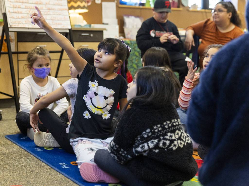 Ruth Zavala, 7, talks through a prompt on the board with a partner during dual language class at Emerson Elementary School on Thursday, Jan. 30, 2025 in Everett, Washington. (Olivia Vanni / The Herald)
