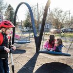 Alina Langbehn, 6, center, and Vera A., 6, right, sit on a swing together at Drew Nielsen Neighborhood Park after school on Tuesday, Jan. 28, 2025 in Everett, Washington. (Olivia Vanni / The Herald)