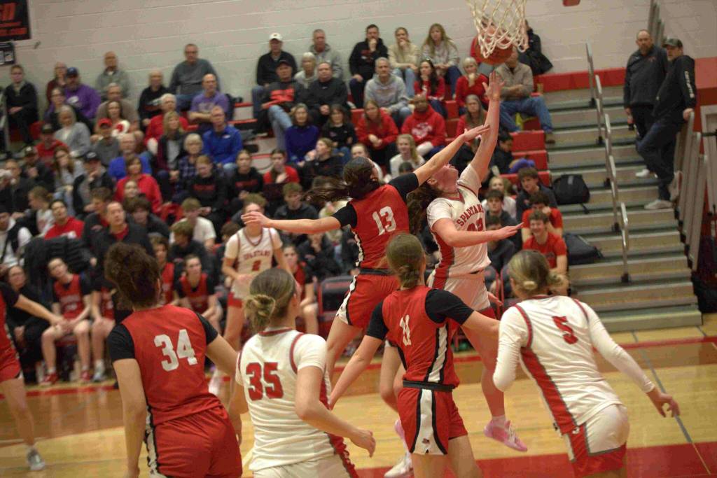 Stanwood guard Jazmyn Legg (22) puts up a shot a Sienna Capelli (13) in a Wesco 3A/2A game in Stanwood on Jan. 31, 2025. (Aaron Coe / The Herald)