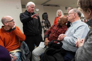 Bill Wood, right, Donnie Griffin, center right, and Steve Hatzenbeler, left, listen and talk with South County Fire Chief Bob Eastman, center left, during an Edmonds Civic Roundtable event to discuss the RFA annexation on Monday, Feb. 10, 2025 in Edmonds, Washington. (Olivia Vanni / The Herald)