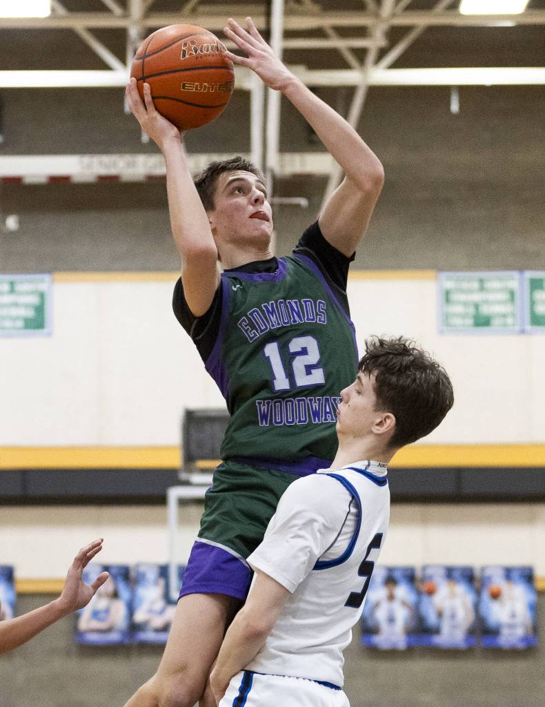 Edmonds-Woodways William Alseth makes a jump shot over the top of Shorewoods Thomas Moles during the game on Tuesday, Feb. 4, 2025 in Shoreline, Washington. (Olivia Vanni / The Herald)