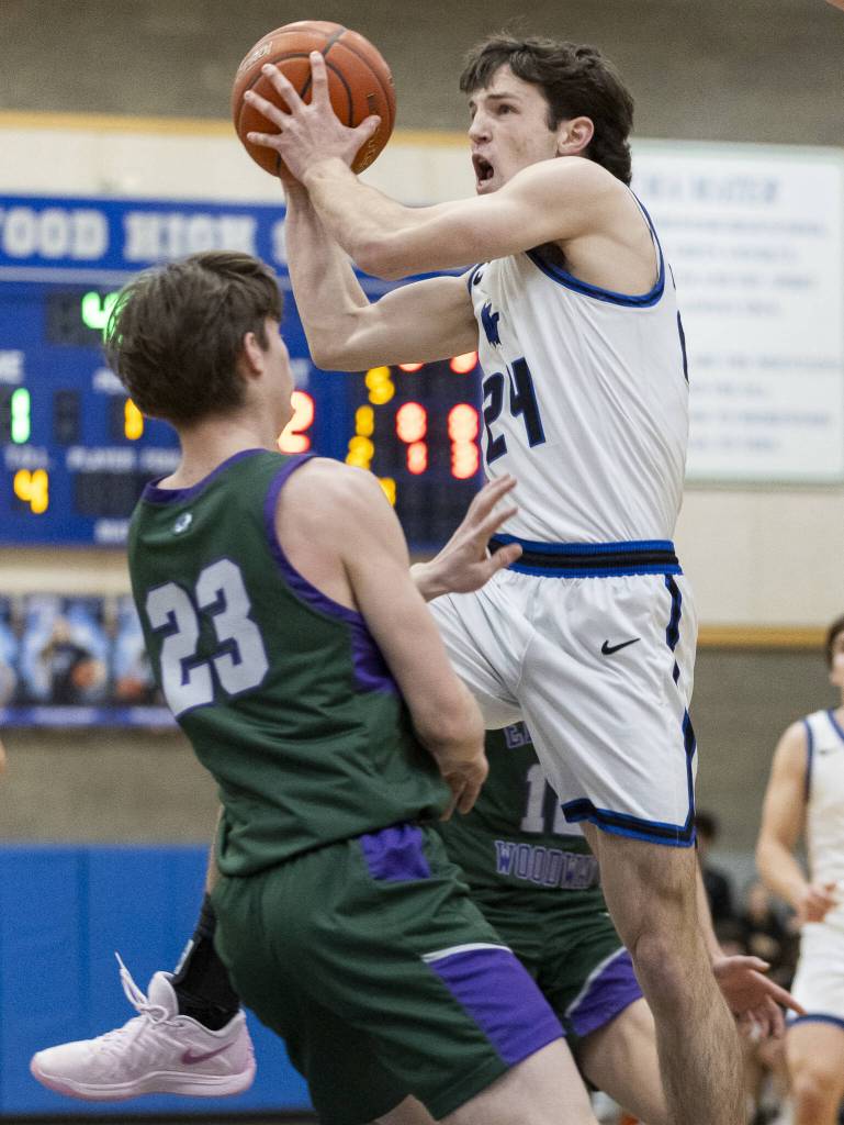 Shorewoods Jaden Marlow tries to make a layup while being guarded by Edmonds-Woodways DJ Karl during the game on Tuesday, Feb. 4, 2025 in Shoreline, Washington. (Olivia Vanni / The Herald)