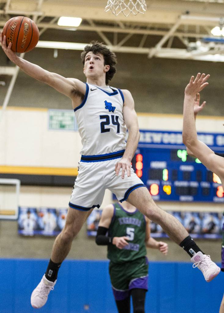 Shorewoods Jaden Marlow leaps in the air to make a layup during the game against Edmonds-Woodway on Tuesday, Feb. 4, 2025 in Shoreline, Washington. (Olivia Vanni / The Herald)